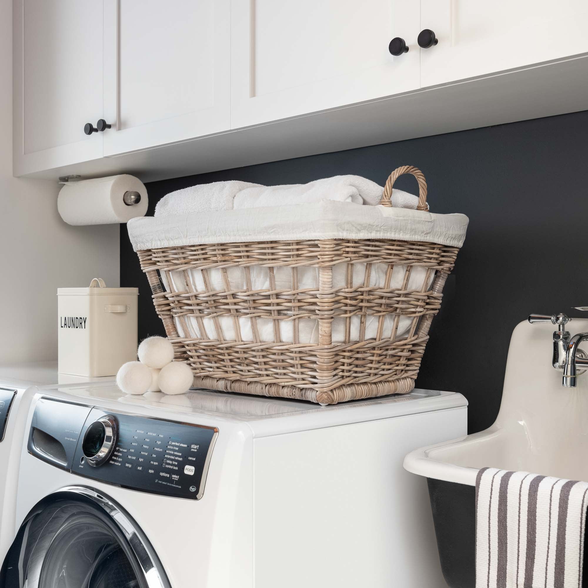 Kubu Wicker French Laundry Basket on washer in laundry room | The Basket Lady