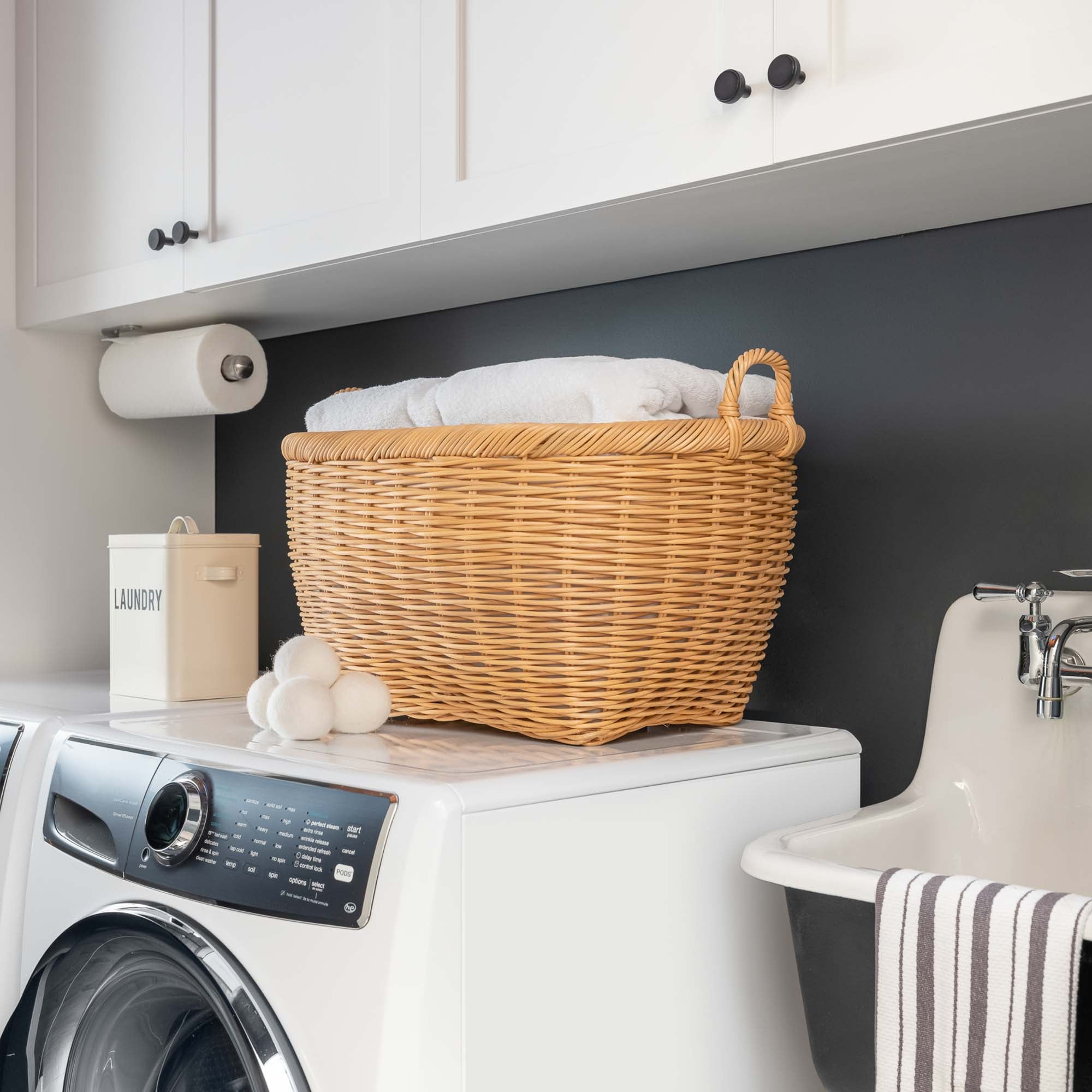 Oval Wicker Laundry Basket in Sandstone in laundry room | The Basket Lady