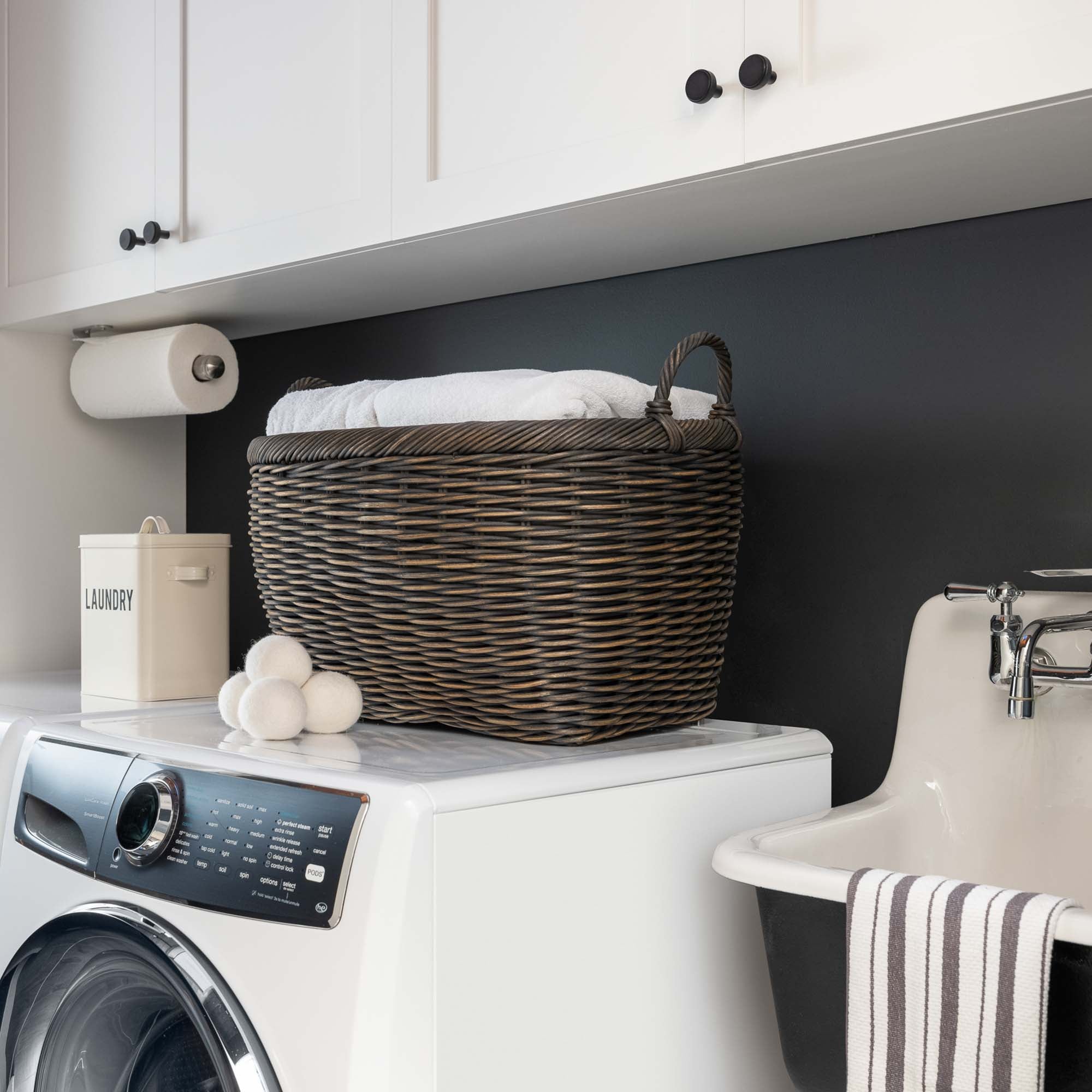 Oval Wicker Laundry Basket in Antique Walnut Brown on washer in laundry room | The Basket Lady